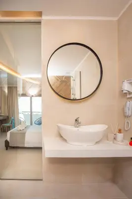 a bathroom with a sink and a mirror at Happy Days Hotel, Adults Only in Theologos