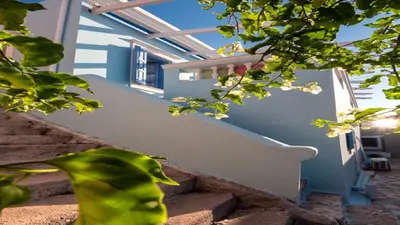 a staircase with white flowers on the side of a house at Amazing House in Halki in Halki