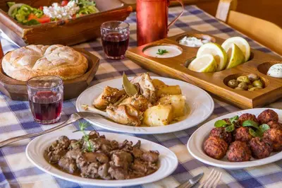 a table with plates of food on a table at Amazing House in Halki in Halki