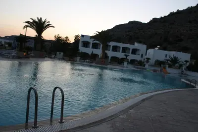 a large swimming pool in front of a building at Coliseum Studios & Apartments in Pefki Rhodes