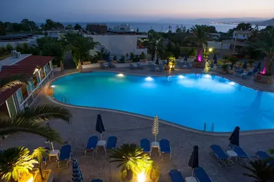 an overhead view of a swimming pool at night at Coliseum Studios & Apartments in Pefki Rhodes