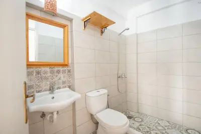 a bathroom with a toilet and a sink at Lindos Marianthi Studios in Líndos