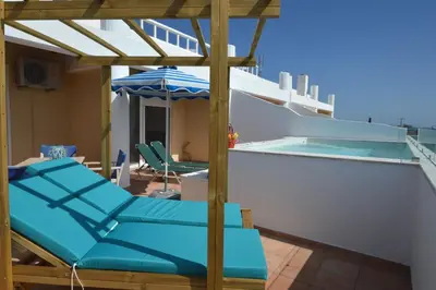 a pool on the roof of a house at Kathara Bay Apartments in Faliraki