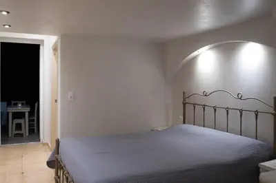 a bedroom with a bed and a hallway with a table at Kathara Bay Apartments in Faliraki