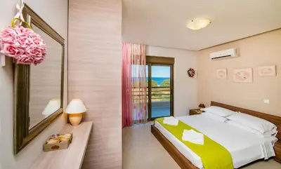 a bedroom with a large bed and a window at Blue Wave Villa in Gennadi