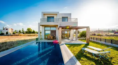a villa with a swimming pool and a house at Blue Wave Villa in Gennadi