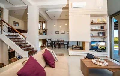 a living room with a couch and a tv at Blue Wave Villa in Gennadi