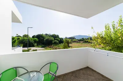 a room with a balcony with two chairs and a view at Anelia Boutique Studios & Apartments in Faliraki
