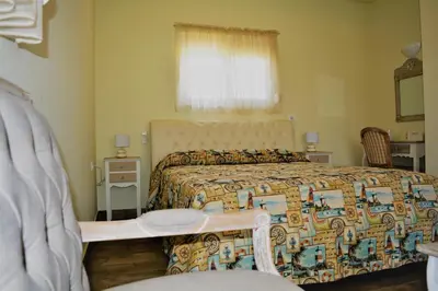 a bedroom with a bed with a colorful blanket at Anelia Boutique Studios & Apartments in Faliraki