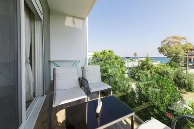 two chairs on a balcony with a view of the ocean at Anelia Boutique Studios & Apartments in Faliraki