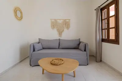 a living room with a couch and a table at Opera House Hotel in Symi