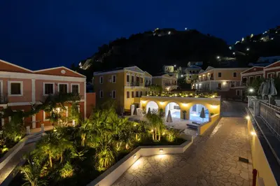 a view of a town at night with lights at Opera House Hotel in Symi
