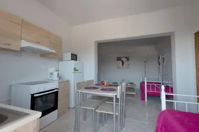a kitchen with a table and a dining room at Rhodes Paulsia Cosy Apartments in Psinthos