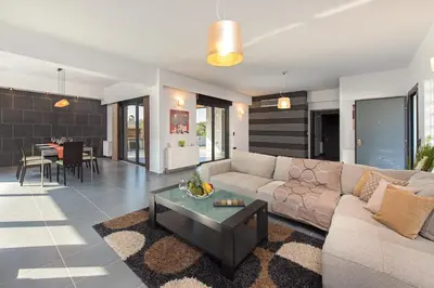 a living room with a couch and a table at Filerimos Garden Villa in Ialyssos