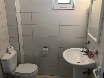 a small bathroom with a toilet and a sink at Kedros Rooms in Prasonisi