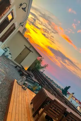 a view of a building with a deck with benches at Villa Acacia in Phanaes