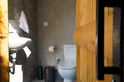 a bathroom with a toilet and a sink at Villa Acacia in Phanaes