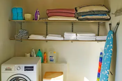 a laundry room with a washing machine and towels at Villa Acacia in Phanaes