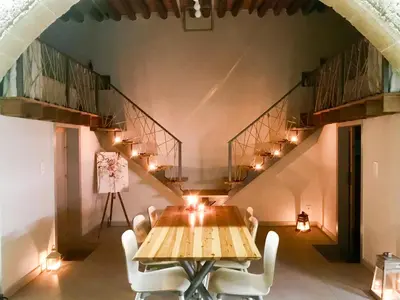 a table and chairs in a room with stairs at Villa Acacia in Phanaes