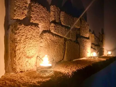 two candles are sitting on a stone wall at Villa Acacia in Phanaes