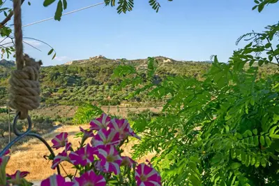 a view of a mountain with purple flowers at Villa Acacia in Phanaes