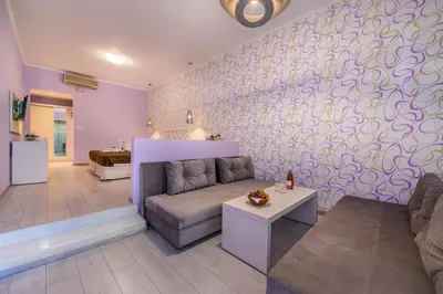 a living room with a couch and a table at Filerimos Village Hotel in Ialyssos