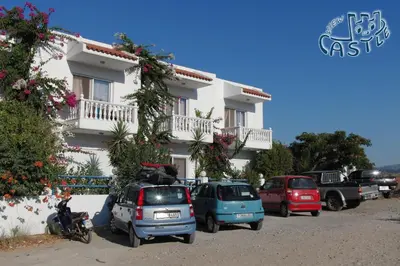 a group of cars parked in front of a building at Castle View Apartments in Haraki