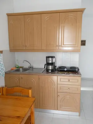 a kitchen with wooden cabinets and a coffee maker on the counter at Castle View Apartments in Haraki