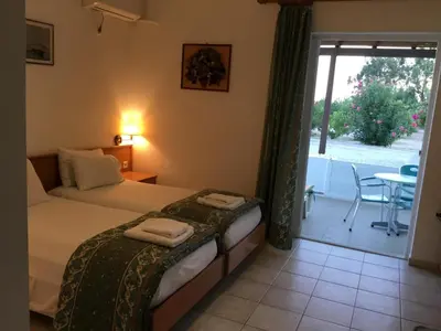 a bedroom with a bed with towels on it at VILLA EIRINI in Pefki Rhodes