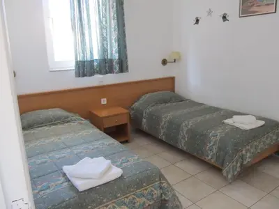 a room with two beds and a window at VILLA EIRINI in Pefki Rhodes