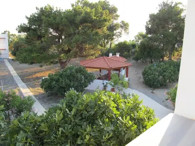 a gazebo in a park with trees and bushes at VILLA EIRINI in Pefki Rhodes