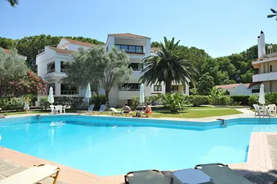 a large swimming pool in front of a building at Niki Hotel Apartments in Ialyssos
