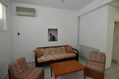 a living room with a couch and two chairs at Niki Hotel Apartments in Ialyssos