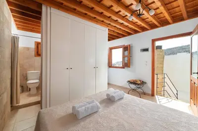 a bedroom with a bed with two towels on it at Villa Valasia Lindos with Acropolis View in Líndos