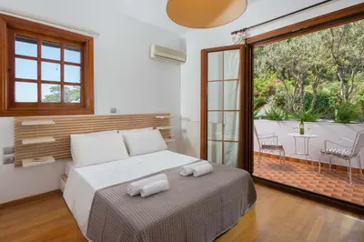 a bedroom with a bed with two towels on it at Una Villa Rhodes in Ixia