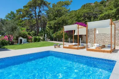 a swimming pool in a yard with a house at Una Villa Rhodes in Ixia