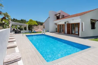 a swimming pool in the backyard of a house at Una Villa Rhodes in Ixia