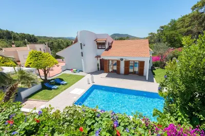 a villa with a swimming pool and a house at Una Villa Rhodes in Ixia