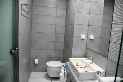 a small bathroom with a toilet and a sink at City Heart Luxury Studio Aurora in Rhodes Town