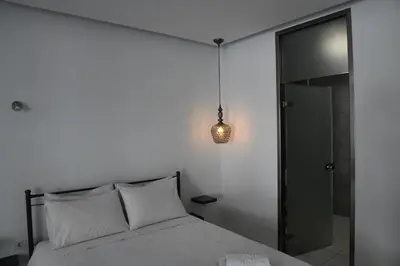 a bedroom with a bed and a pendant light at City Heart Luxury Studio Aurora in Rhodes Town