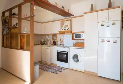a kitchen with a white refrigerator and a dishwasher at Mata's Sea House in Lachania
