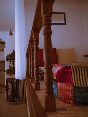a living room with a bed and a stairway with at Mata's Sea House in Lachania