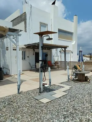 a patio with a table and a wooden structure at Mata's Sea House in Lachania
