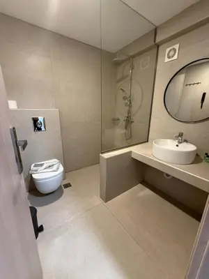 a bathroom with a toilet and a sink and a mirror at Sunrise Luxury Apartments Rhodes in Rhodes Town