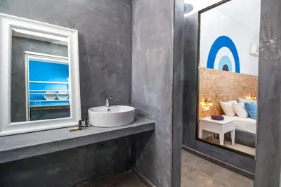a bathroom with a sink and a mirror at Tinas Plus Hotel in Faliraki