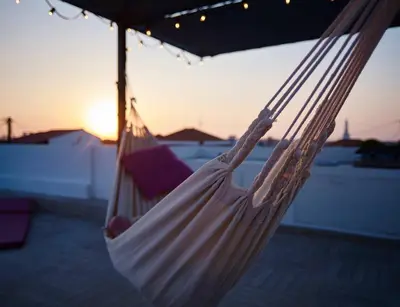 a white hammock with the sunset in the background at Kalithea Hills Appartment 1 in Koskinou