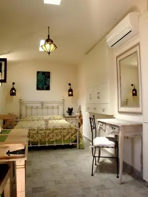 a bedroom with a bed and a table and a desk at Bright Sun Villas in Halki