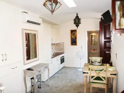 a kitchen with a table and a dining room at Bright Sun Villas in Halki
