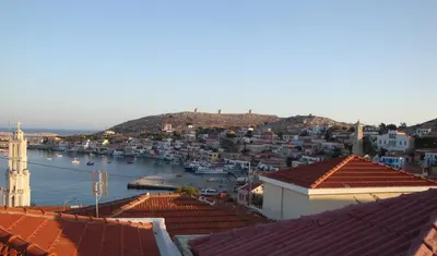a view of a city with boats in the water at Bright Sun Villas in Halki