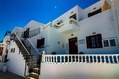 a white building with stairs on the side of it at Domna Studios in Líndos